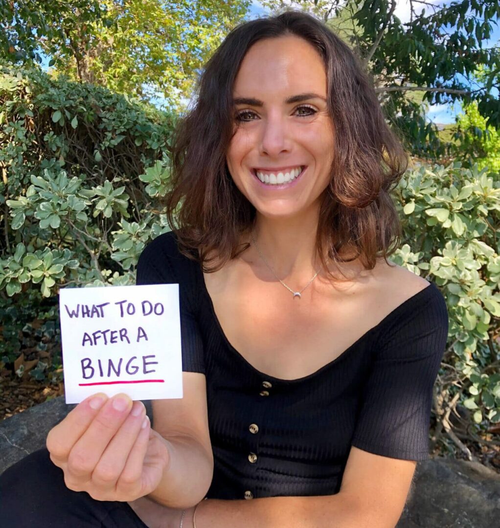 Brittany is holding a sign that reads, "What do do after a binge"